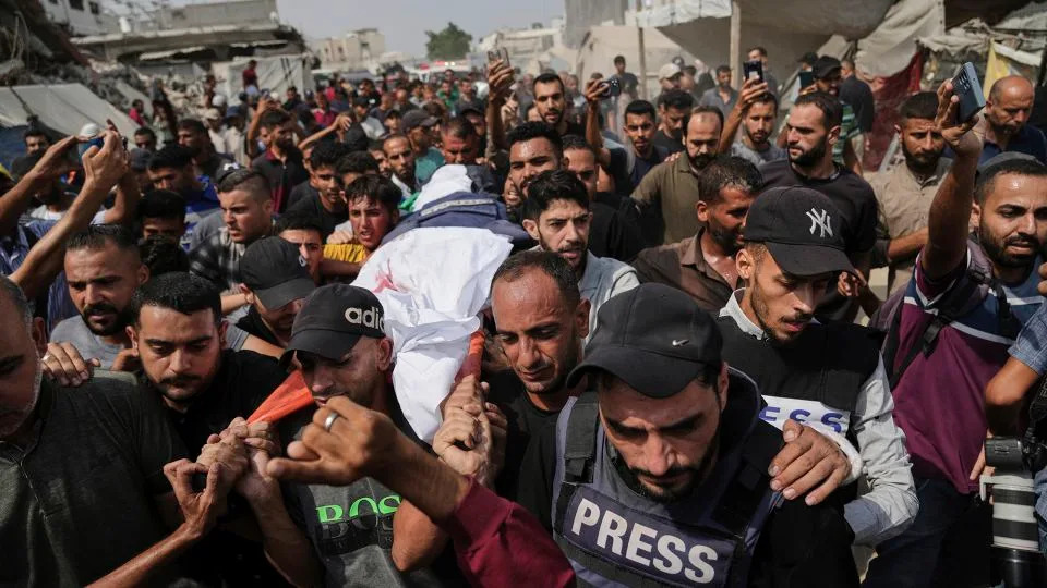 Palestinians carry the body of Al Jazeera reporter Anas Al-Sharif, who, along with other journalists, was killed in an Israeli airstrike, during his funeral outside Gaza City's Shifa hospital complex on August 11. - Jehad Alshrafi/AP