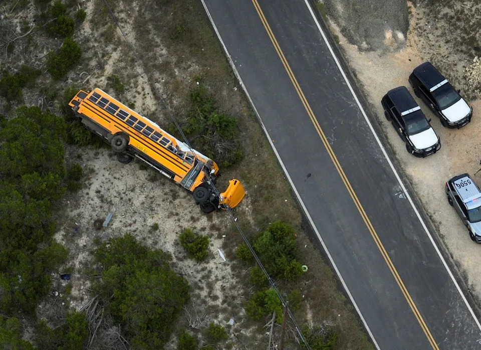 A Texas school bus carrying 43 people, mostly elementary school students, rolled onto its side after the vehicle veered off the road on the first day of class (© 2025 Jay Janner / Austin American-Statesman)
