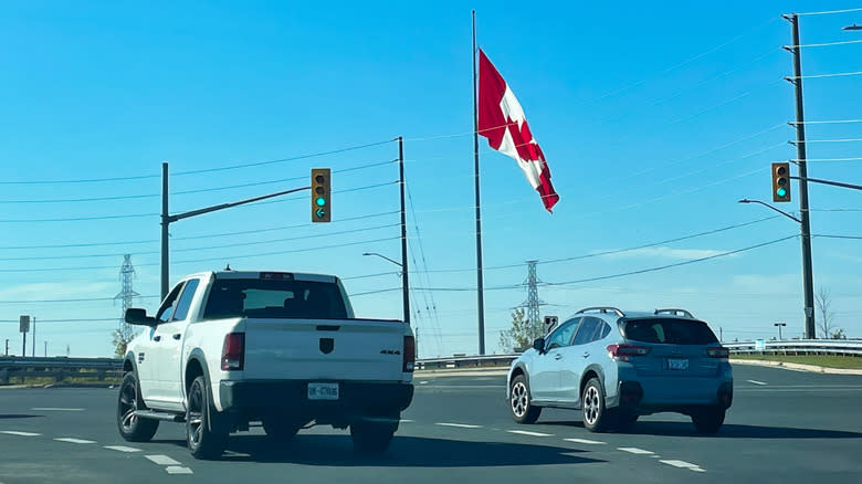 Canadian flag over cars in Oshawa, Ontario
