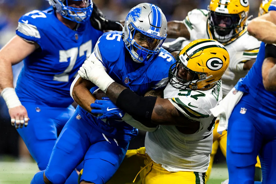 DETROIT, MICHIGAN - DECEMBER 5: Kenny Clark #97 of the Green Bay Packers tackles David Montgomery #5 of the Detroit Lions in the second quarter of the game at Ford Field on December 5, 2024 in Detroit, Michigan. The Lions beat the Packers 34-31. (Photo by Lauren Leigh Bacho/Getty Images)
