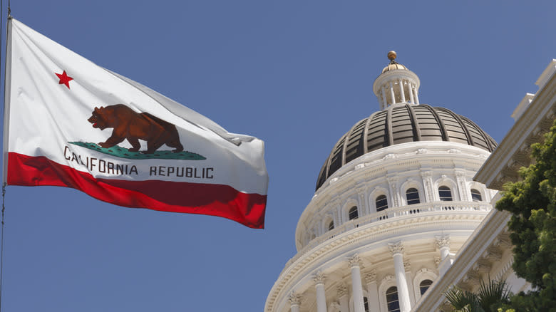 A state flag of California waving at the California State Capitol in Sacramento