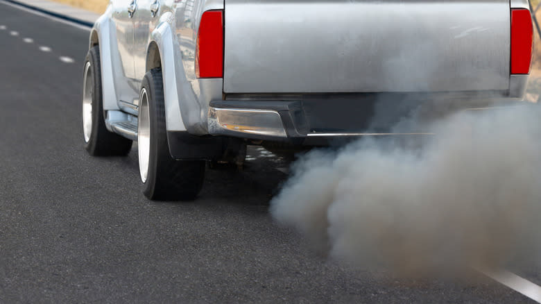 A diesel truck belching thick clouds of dark smoke