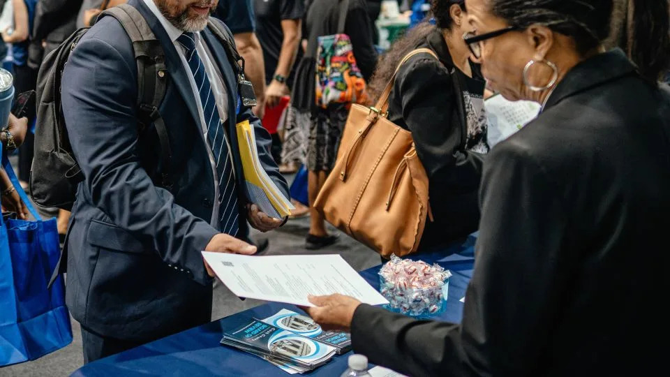 Recruiters and job seekers speak during a job fair hosted by the Cook County government to support federal workers in Chicago, Illinois, on Thursday, June 26, 2025. - Jamie Kelter Davis/Bloomberg/Getty Images