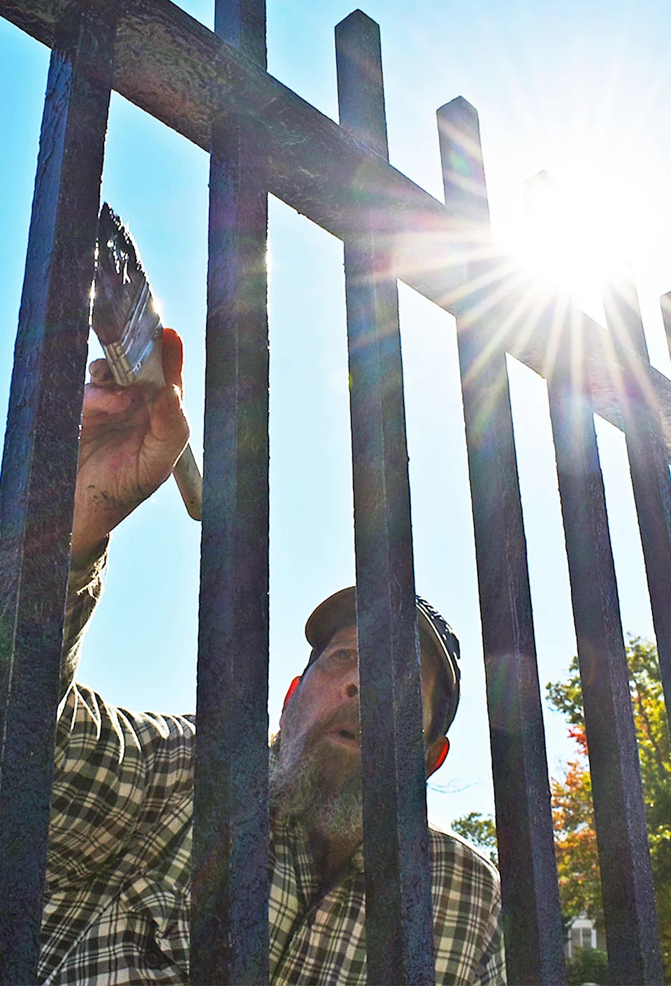 Jeff Heaberlin paints an iron fence on North Main Street in Fall River on Friday, Oct. 18, 2024.