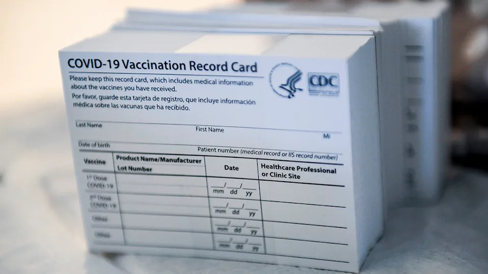 A stack of COVID-19 Vaccination Record Cards from the CDC.