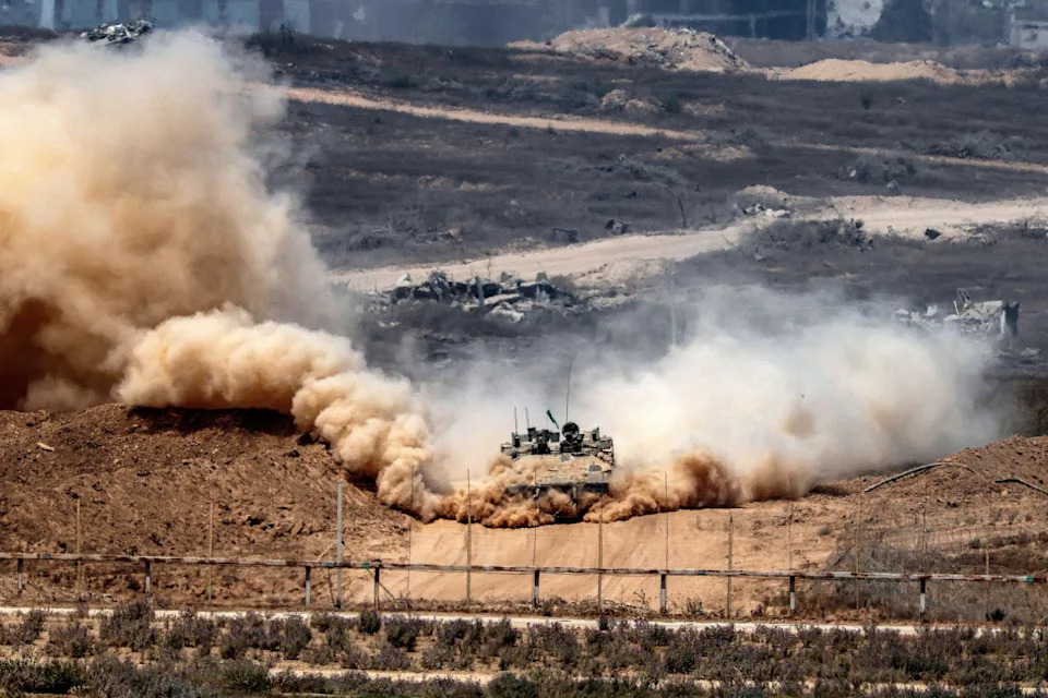 AFP via Getty Images - PHOTO: An Israeli army infantry-fighting vehicle leaves a cloud of dust as it moves at a position along Israel's southern border with the Gaza Strip on August 5, 2025.