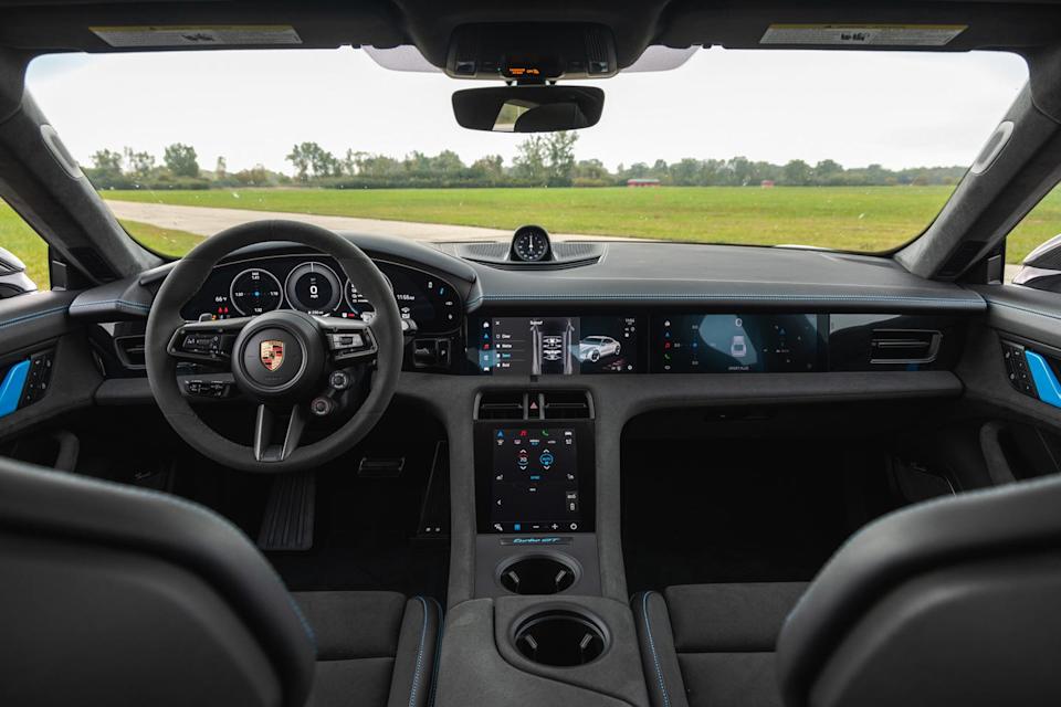 interior of a porsche taycan turbo gt featuring a digital dashboard, multifunction steering wheel, and touchscreen displays.
