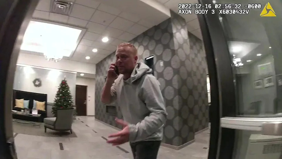 Matthew Ecker meets St. Paul police officers responding to his 911 call in the lobby of Alex Pennig's apartment building. / Credit: Ramsey County District Court