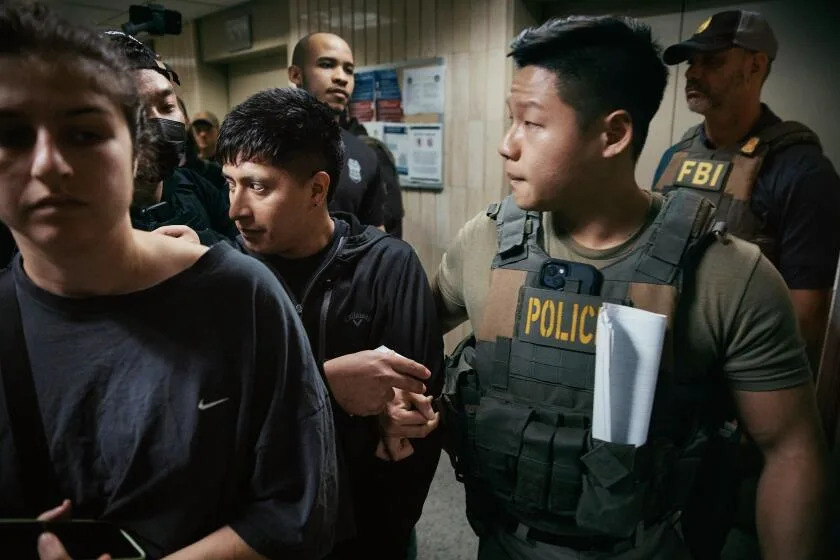 Federal agents detain a person after an immigration hearing inside the Jacob K. Javits Federal Building in New York City.