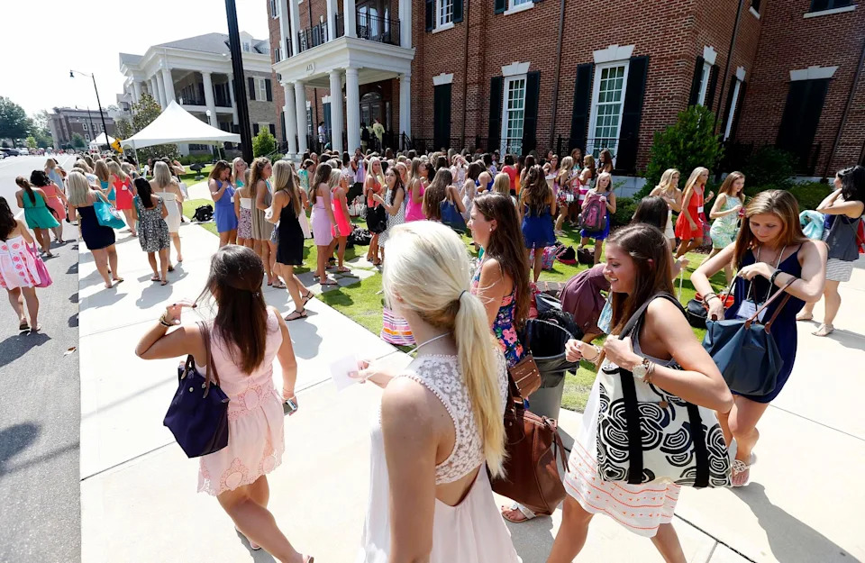 Potential new members walk between houses on Magnolia Drive to their next parties during the annual fall formal sorority recruitment at the University of Alabama Saturday, Aug. 9, 2014. Recruitment officially began Friday, Aug. 8, with Convocation and ends on Saturday Aug. 16 with Bid Day. Approximately 2300 potential new members participated in the event. Saturday included open house and ice tea parties. Michelle Lepianka Carter | The Tuscaloosa News