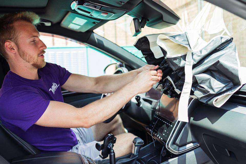 a man installing an umbrella style car sun shade