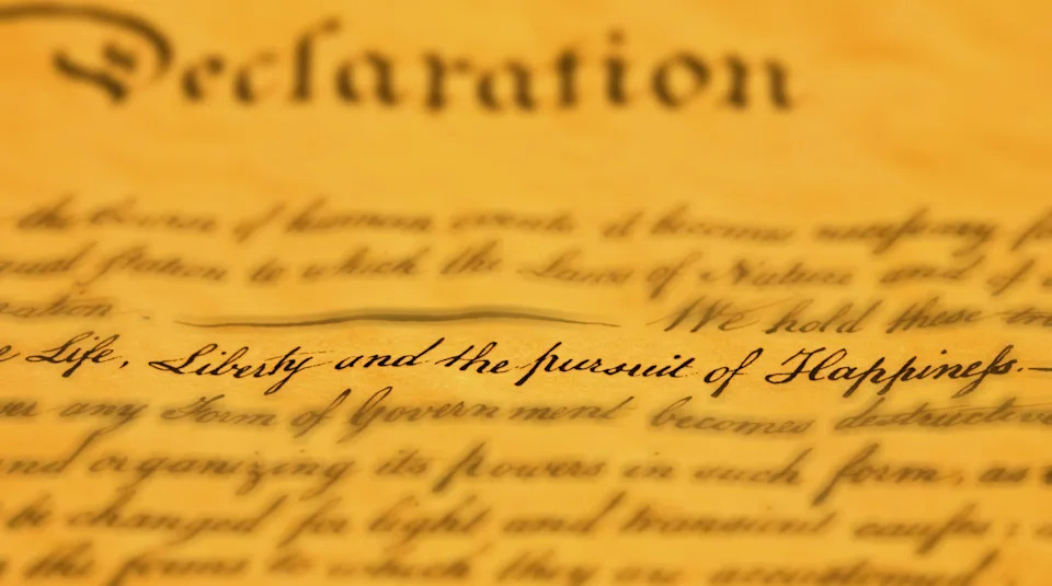 Close-up of the U.S. Declaration of Independence text, highlighting "Life, Liberty and the pursuit of Happiness."