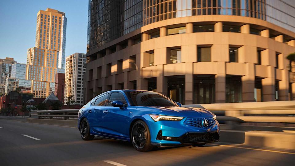 Dynamic front 3/4 shot of a blue 2026 Acura Integra driving in a city.