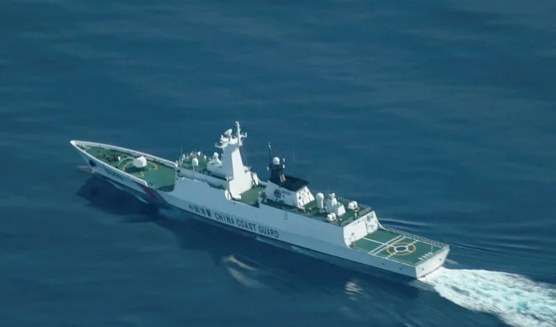 China's military, coast guard patrol disputed South China Sea atoll