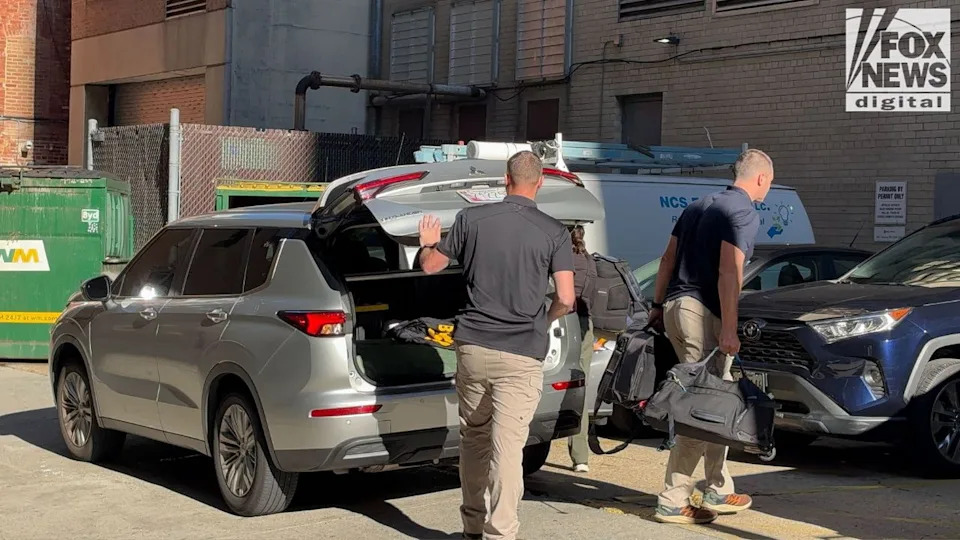 FBI agents load bags into a vehicle after searching John Bolton’s D.C. office, Aug. 22, 2025.