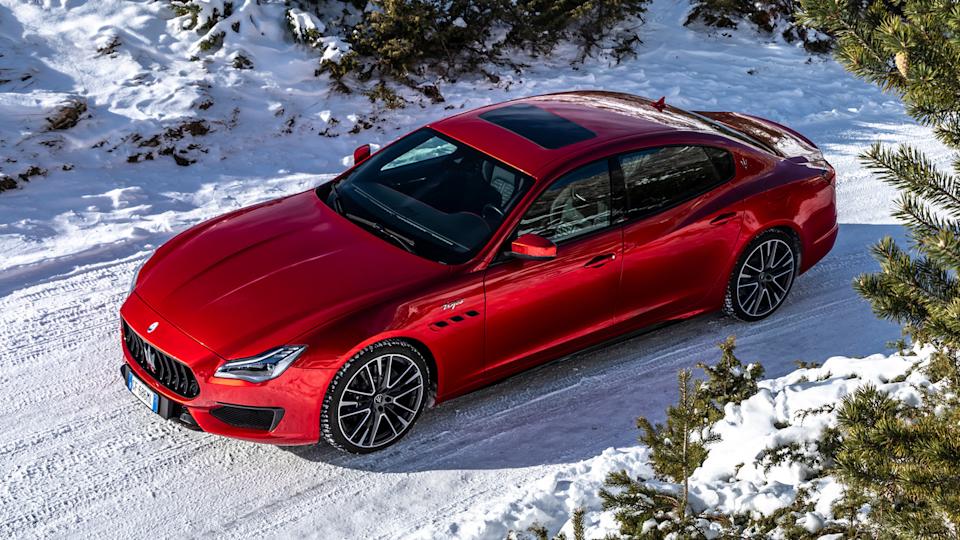 Rosso Magma 2023 Maserati Quattroporte Trofeo Parked In The Snow Front 3/4 View