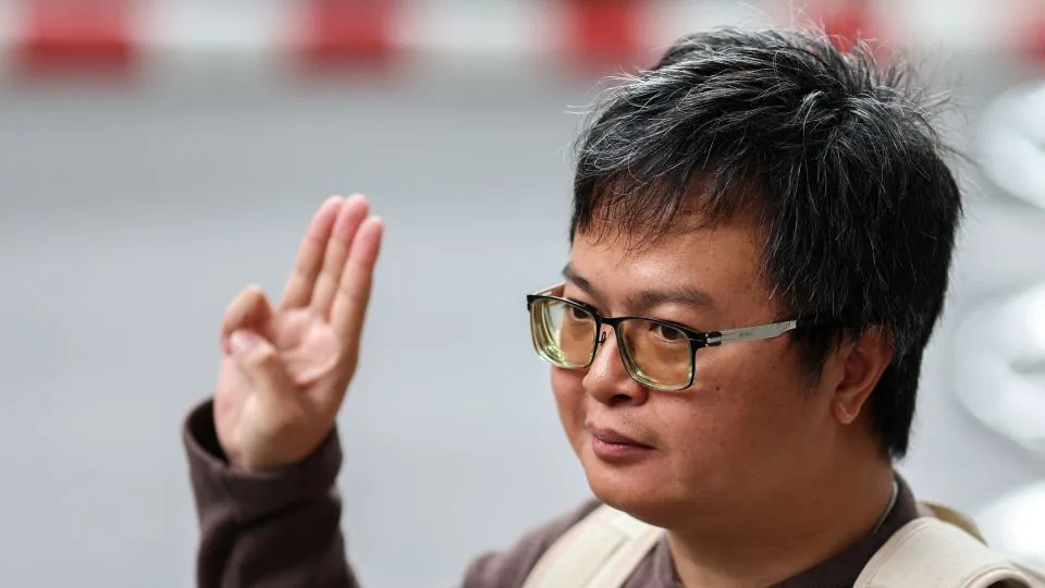 Arnon Nampa, a prominent activist and human rights lawyer, flashes a three finger salute at the criminal court in Bangkok, Thailand, on September 26, 2023. - Athit Perawongmetha/Reuters