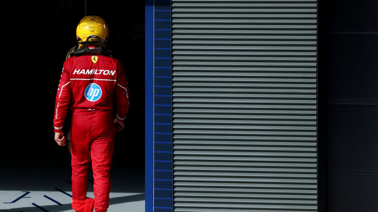 Lewis Hamilton of Ferrari walks back into the pits.