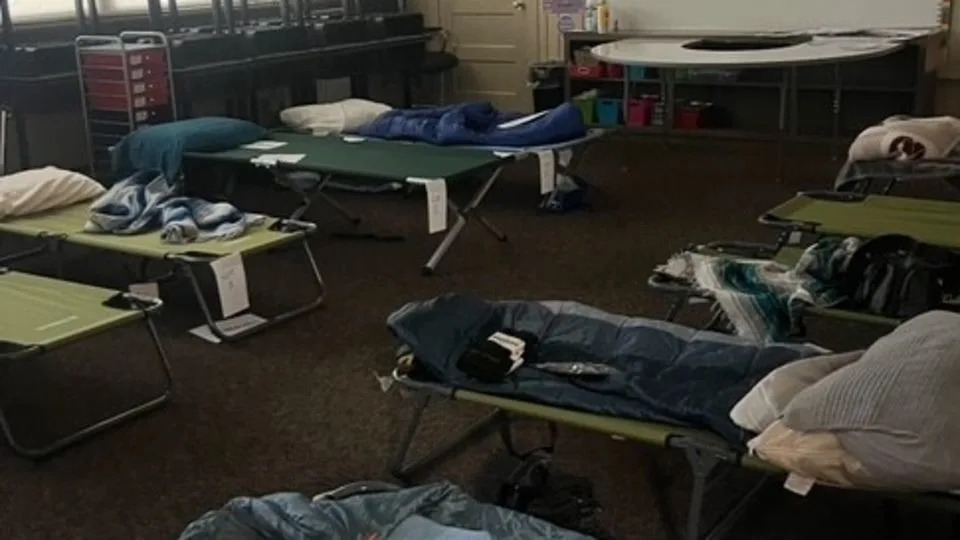 Cots are seen in this photo set up on the floor of a classroom in Hunt School. - Houston Fire Department Search and Rescue