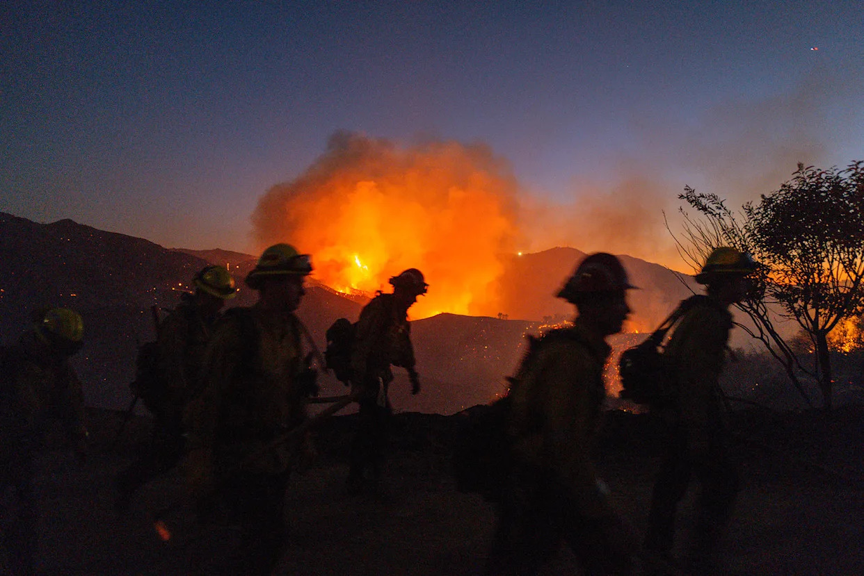 Firefighters in the growing Palisades Fire in Los Angeles County, Calif. on Jan. 11. (Ali Matin / Middle East Images/AFP via Getty)