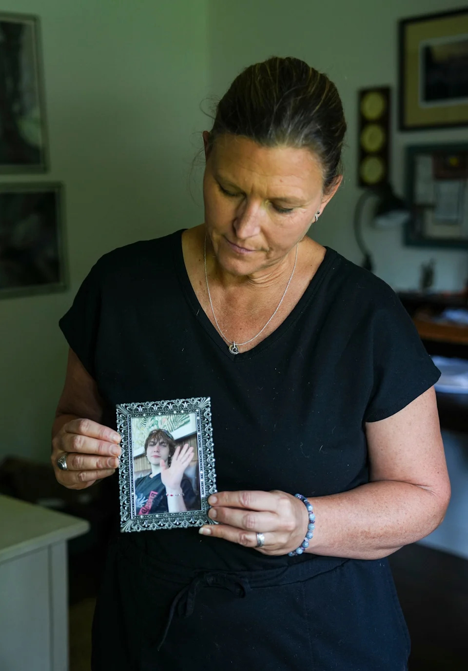 Laura Herp shows a photo of her son Henry Willis, who she lost to suicide. A lawsuit alleges Willis ordered parts of a gun on the internet, even though he was not of age under federal firearms laws. July 28, 2025.