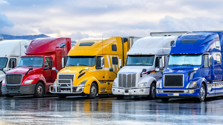 A lineup of American long-nose semi trucks