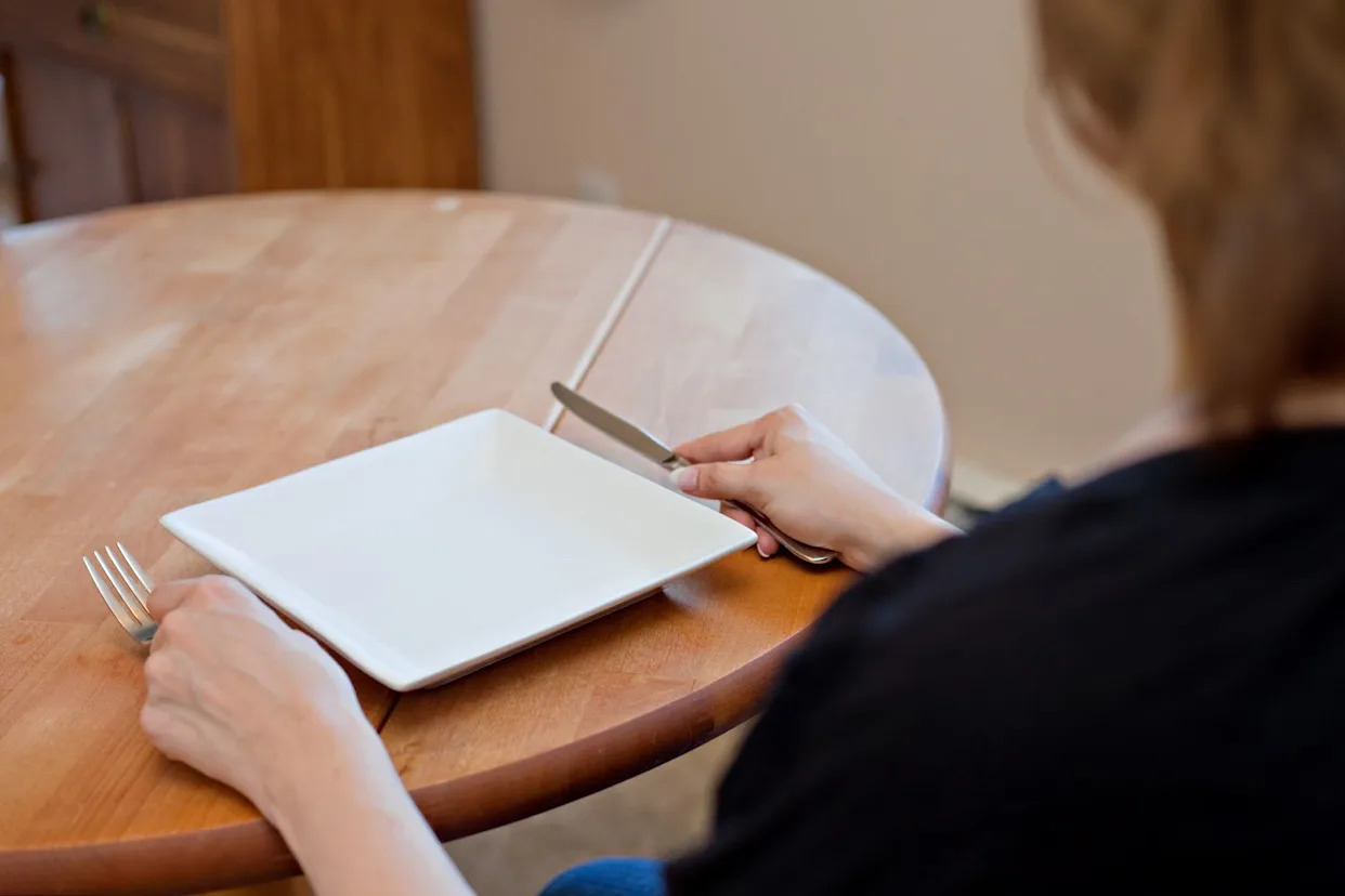 Getty Stock photo of a woman with an empty plate