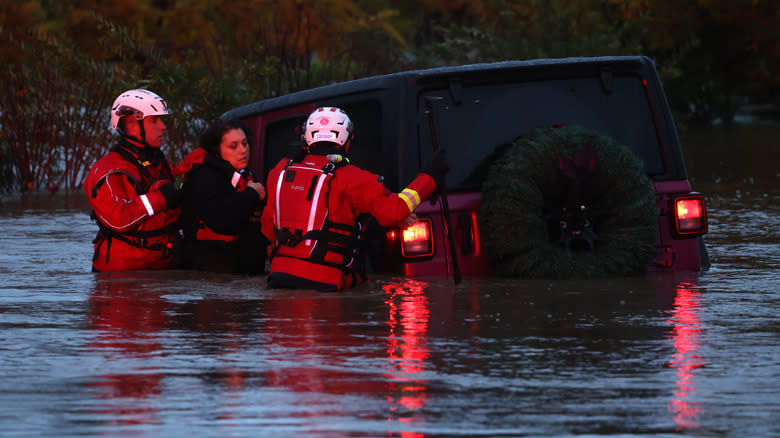 Firefighters rescue a couple after their car got stuck in deep floodwaters on November 22, 2024 in Windsor, California. A powerful atmospheric river is bringing heavy rains and wind to the San Francisco Bay Area for the third straight day and is expected to rain through the weekend.
