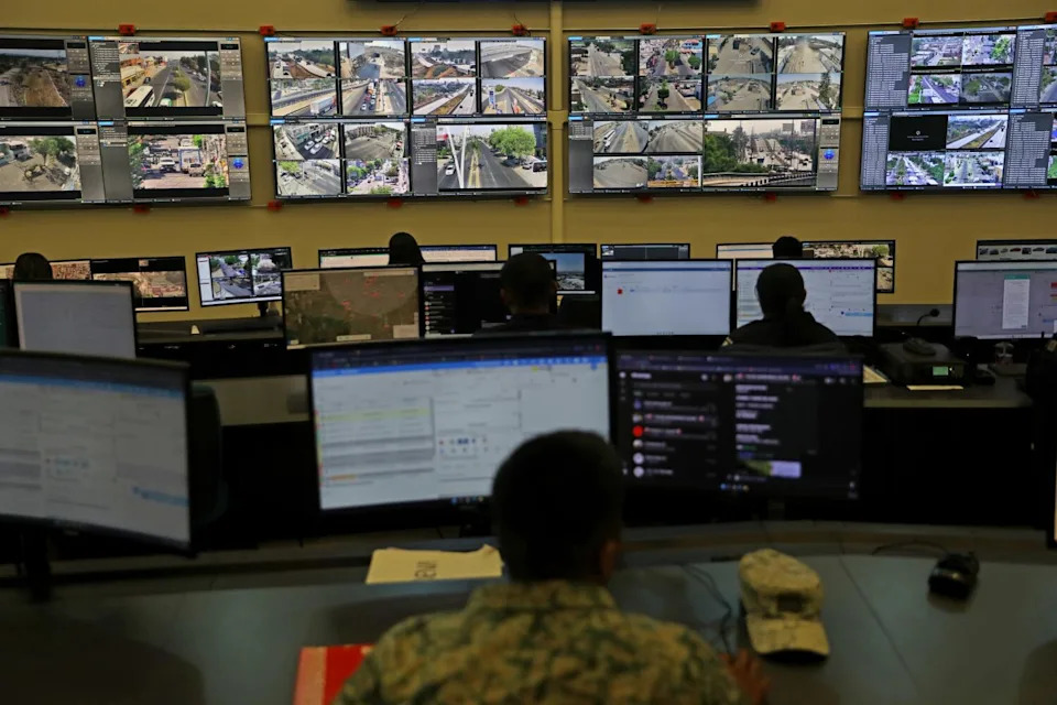 A wall of surveillance monitors.