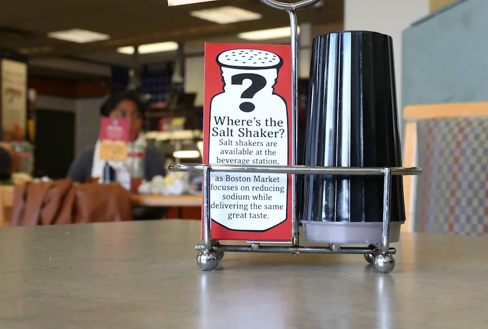 A sign explaining the absence of salt shakers is posted on a table inside a Boston Market restaurant on August 21, 2012 in San Francisco, California.