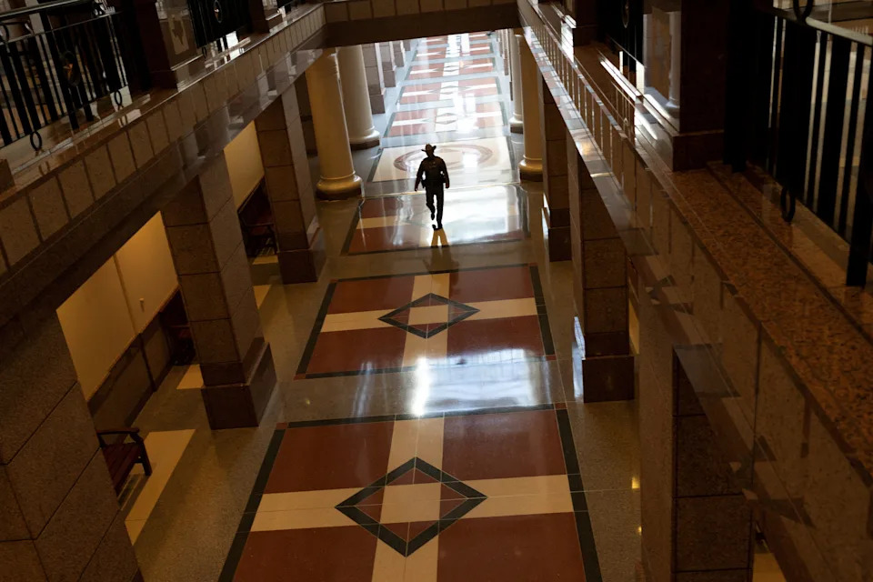 A state trooper walks through the Texas Capitol extension prior to the House coming into session for the fifth time since Democratic lawmakers left the state to deny Republicans the quorum needed to redraw the state's 38 congressional districts, at the Texas State Capitol in Austin, Texas, U.S. August 8, 2025.