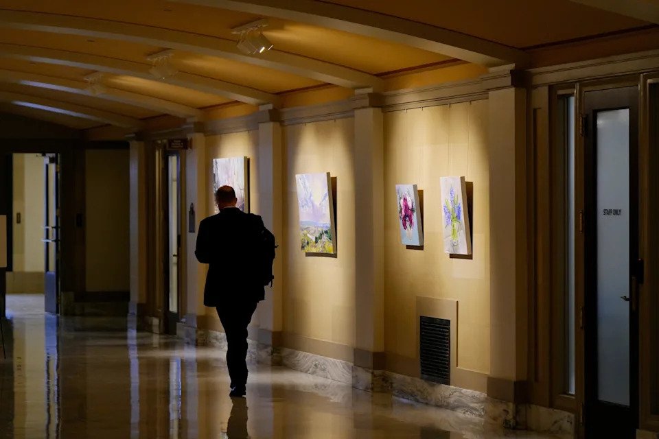 In March, a man walks down the east hall gallery on the first floor of the state Capitol. The Oklahoma Arts Council is taking cost-cutting measures, including suspending its program of rotating exhibitions in the Oklahoma State Capitol galleries.