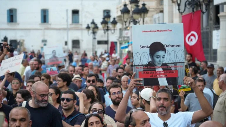 A man displays a sign as protesters rally against Tunisian President Kais Saied on the fourth anniversary of his power grab, in Tunis, Tunisia, July 25, 2025. Demonstrators denounced Saied’s rule as authoritarian, calling the country an
