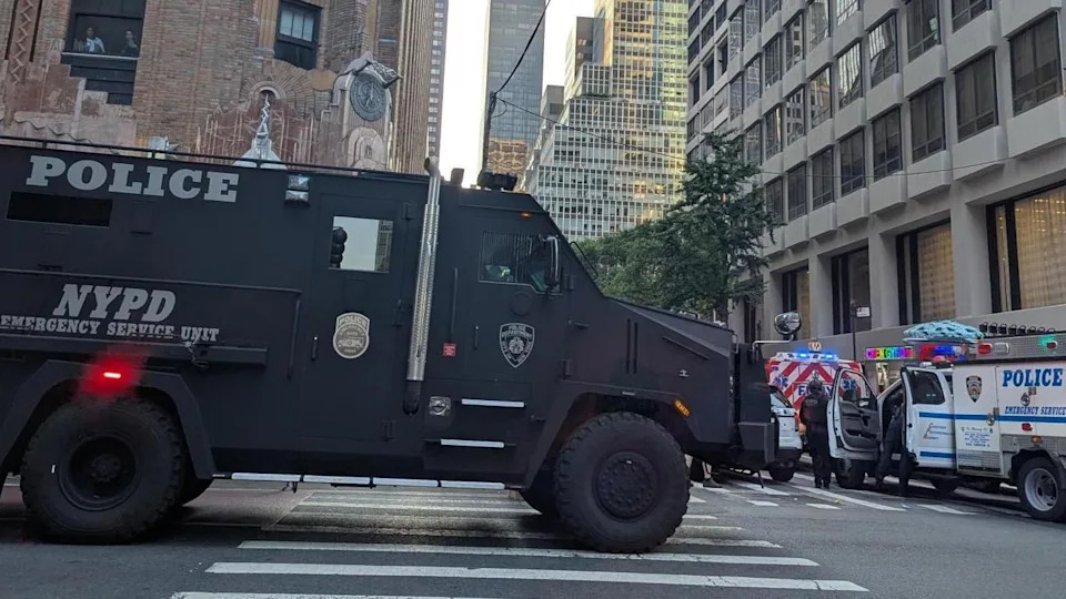 Scores of police vehicles are parked in New York City amid reports of shots fired in a skyrise 