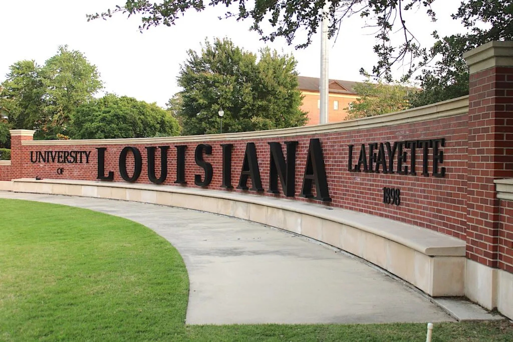 Large letters hang from a 30-yard, 7-foot-tall curving brick wall to spell out University of Louisiana at Lafayette and 1898, the year it was founded.