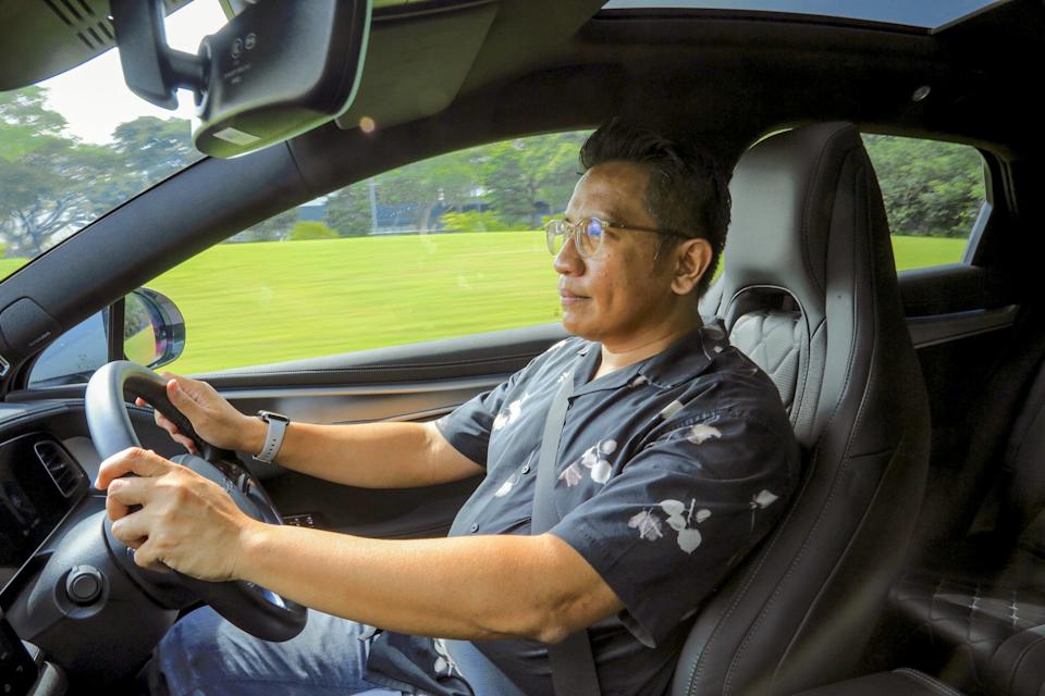 A man driving a BYD Sealion 7.