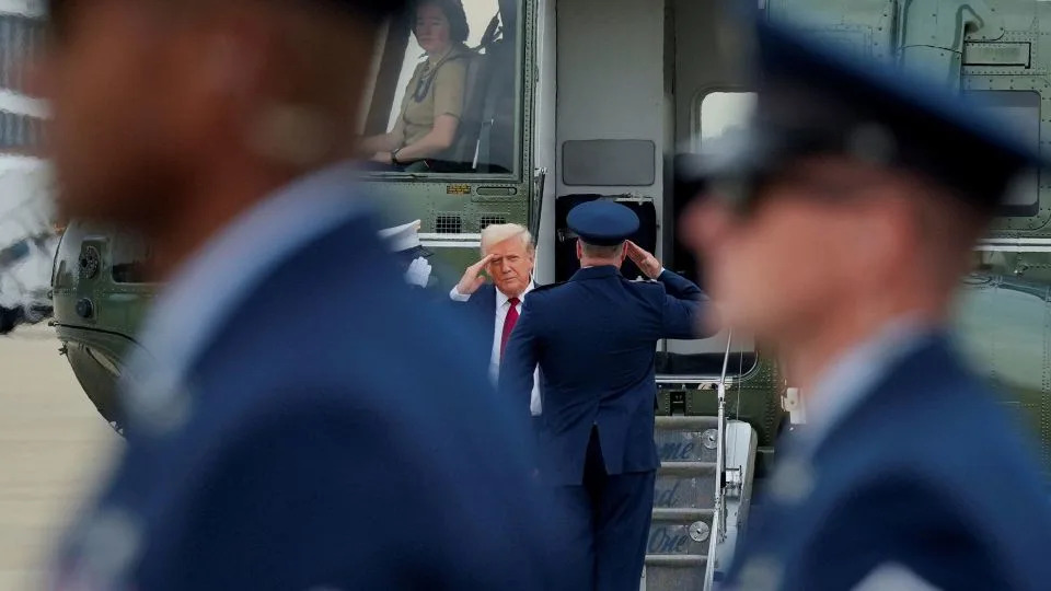 President Donald Trump salutes members of the military as he arrives to board Air Force One at Joint Base Andrews, Maryland, on August 1. - Ken Cedeno/Reuters