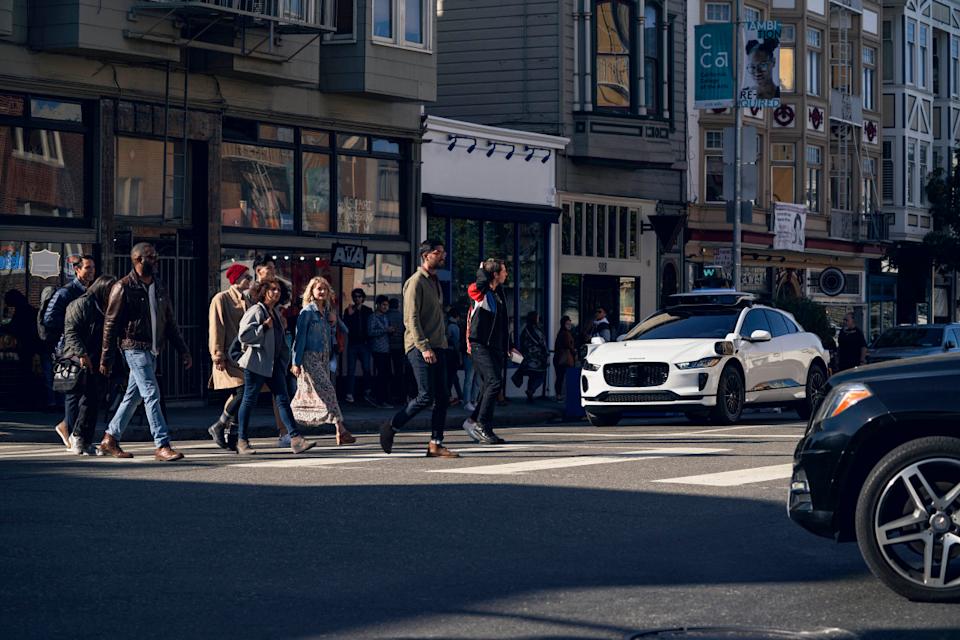 A Waymo car stopped in front of a crosswalk Waymo
