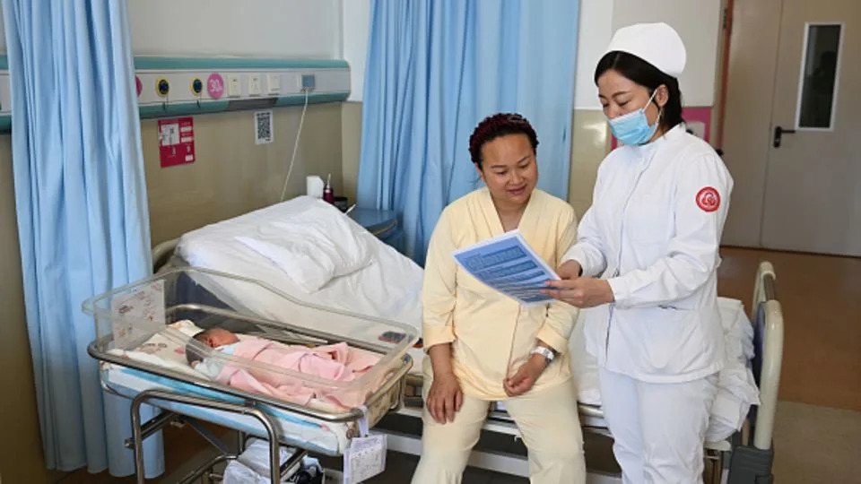 A medical worker explains local childcare subsidies at a hospital on March 16, 2025 in Hohhot, Inner Mongolia of China. - China News Service/Getty Images