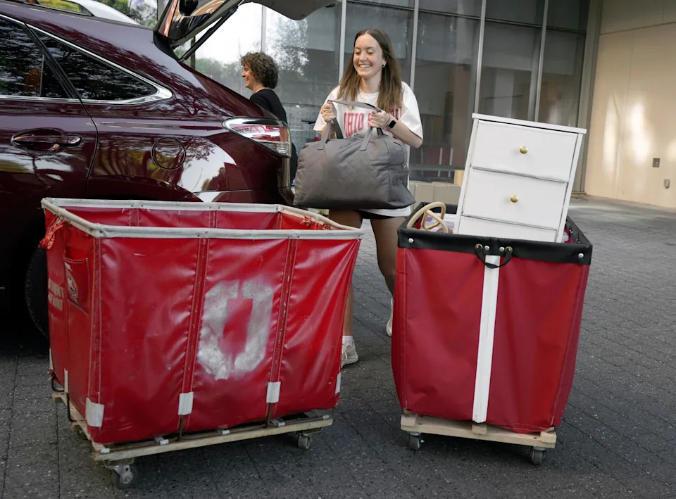 Anysia Reimund of Akron loads up rolling bins with her mother Stephanie Reimund’s assistance outside Smith-Steeb Hall on Aug. 14, 2024. This year, the first day of Ohio State University's move-in week will begin Aug. 20.