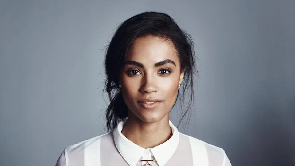 Sinead Bovell - a woman with black hair and wearing a white shirt 