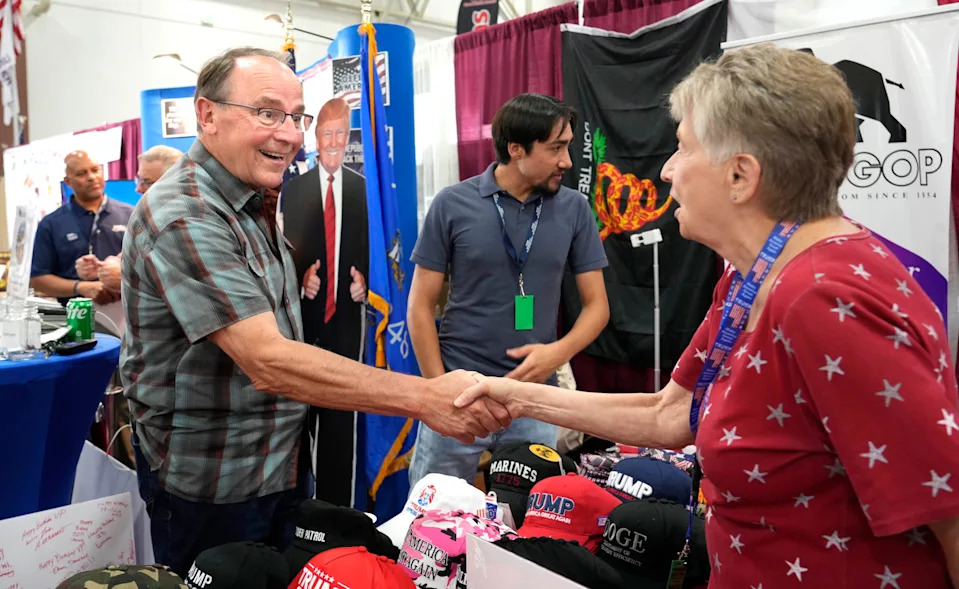 U.S. Congressman Tom Tiffany, left, greets a supporter while visiting the Wisconsin State Fair on Monday, Aug. 4, 2025. Tiffany was at the fair to sign the Parent Pledge for Moms for Liberty and discuss federal issues concerning Title IX and education.