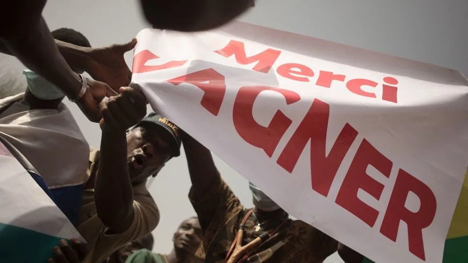 Protesters hold a banner reading "Thank you Wagner" during a demonstration organized to celebrate France's announcement it would withdraw French troops from Mali, in February 2022. - Florent Vergnes/AFP/Getty Images