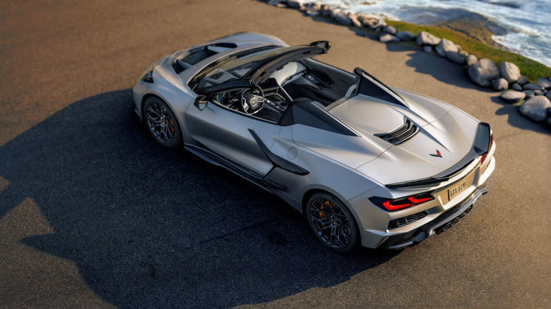 an overhead view of the 2026 Corvette ZR1X Quail Silver Limited Edition with its top retracted next to the sea