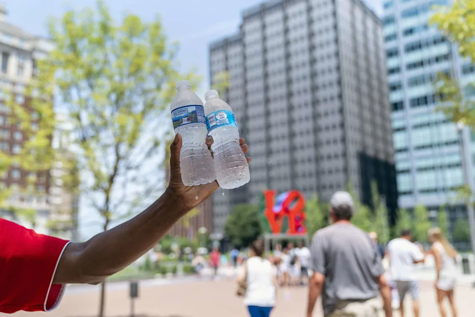 Jessica Kourkounis/Getty Images - PHOTO: A man sells bottles of water in sweltering heat on July 1, 2018 in Philadelphia.