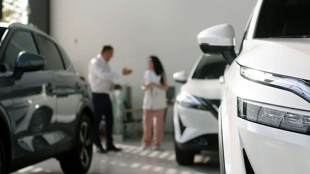 A manager and an interested buyer in a car dealership. - wedmoments.stock // Shutterstock