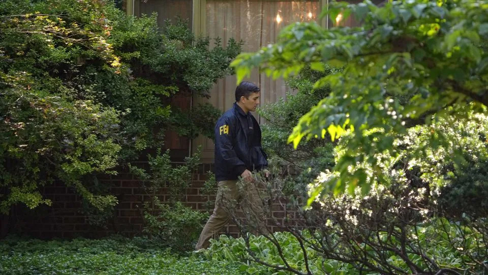 An FBI agent work outside the home of John Bolton in Bethesda, Maryland, on Friday - Andrew Harnik/Getty Images