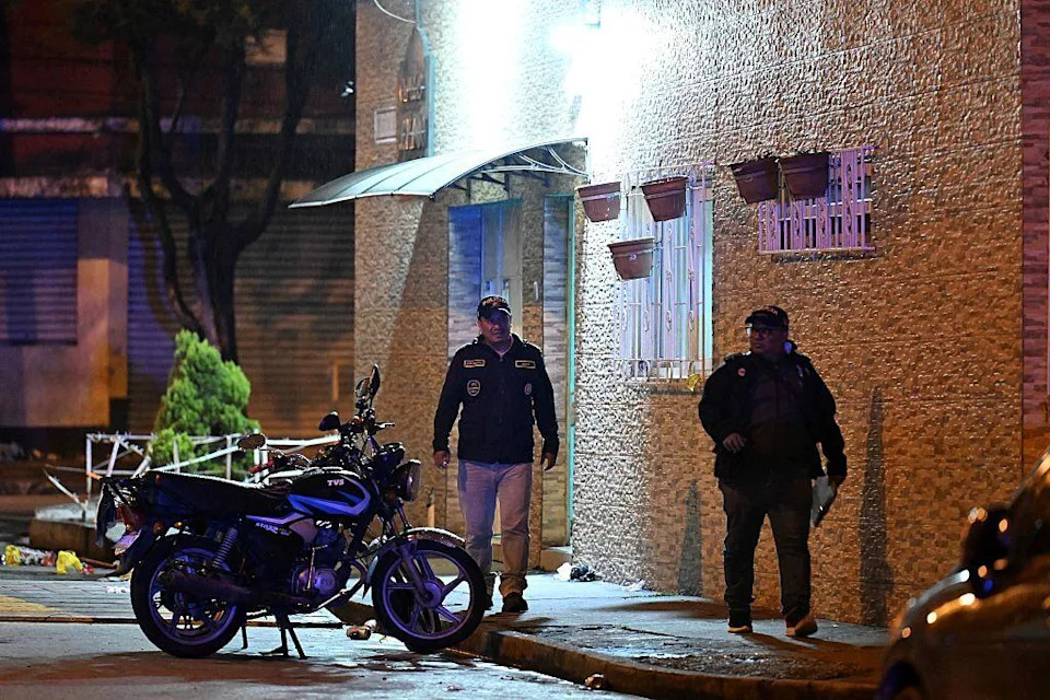 Police officers look for evidence next to a crime scene where seven people were killed in an attack by suspected gang members at a funeral home in Guatemala City on July 30, 2025. / Credit: JOHAN ORDONEZ/AFP via Getty Images