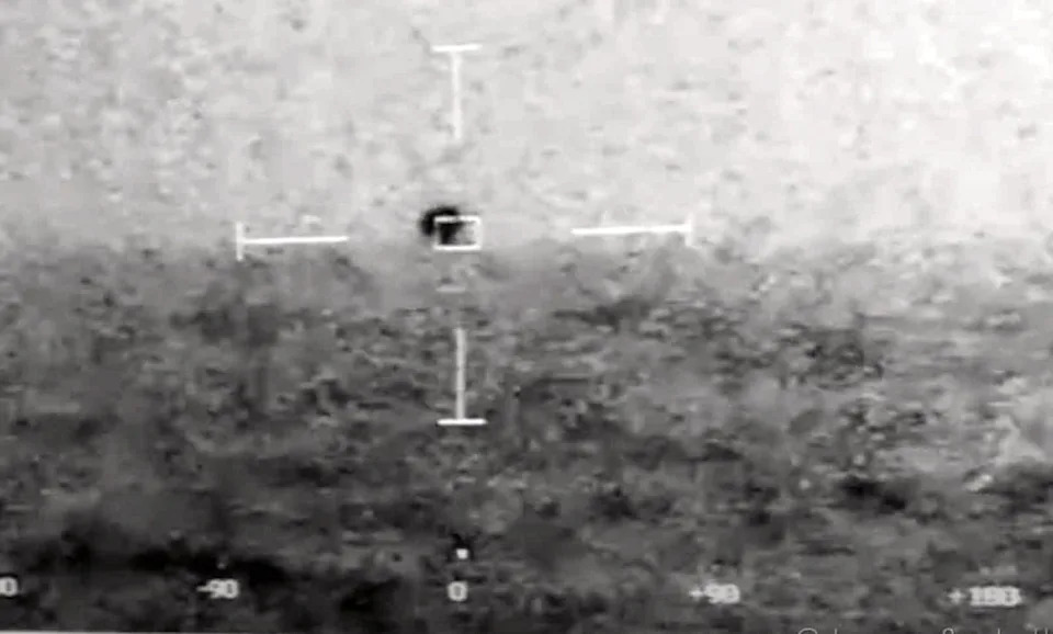 thermal image showing a dark object with a target reticle