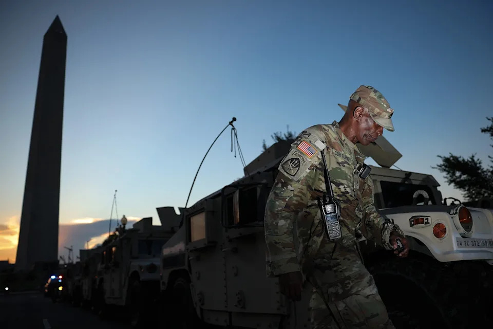 Win McNamee/Getty Images - PHOTO: A member of the DC National Guard joins his unit near the Washington Monument on August 12, 2025 in Washington.